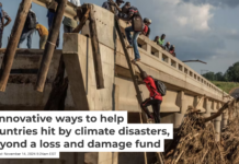 People climb to the top of a bridge damaged when Cyclone Idai hit Mozambique in 2019. Andrew Renneisen/Getty Images